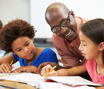 Man helping children write and learn, with S.L. Hunter Speechworks in Burlington Ontario